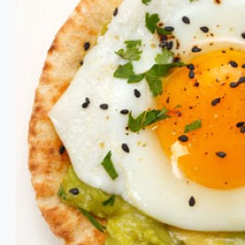 A pita with an egg and avocado.