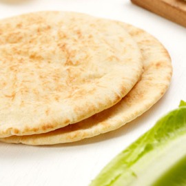 Some pitas on a table.