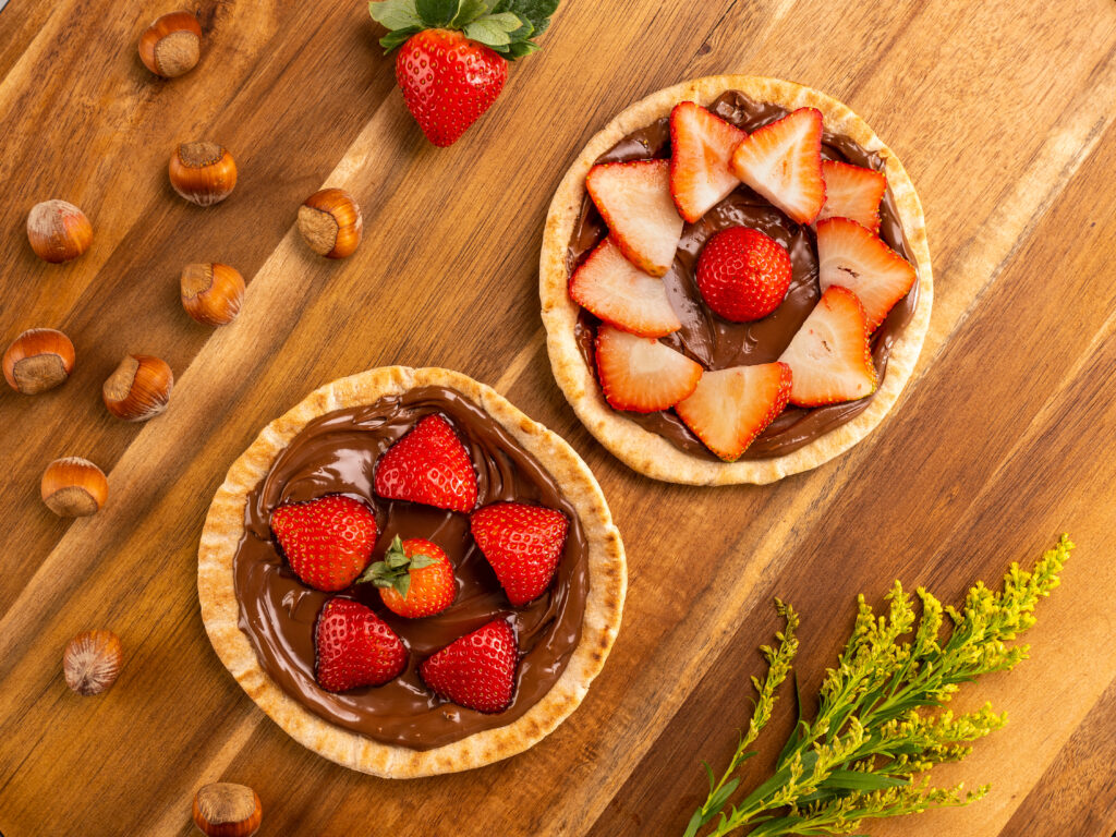 Chocolate Hazelnut Strawberry Pitas on a wooden cutting board
